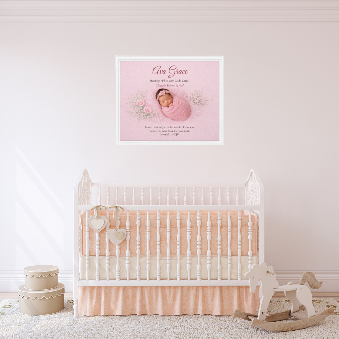 Baby crib with pink bedding and a framed photo of a baby on the wall in a nursery.