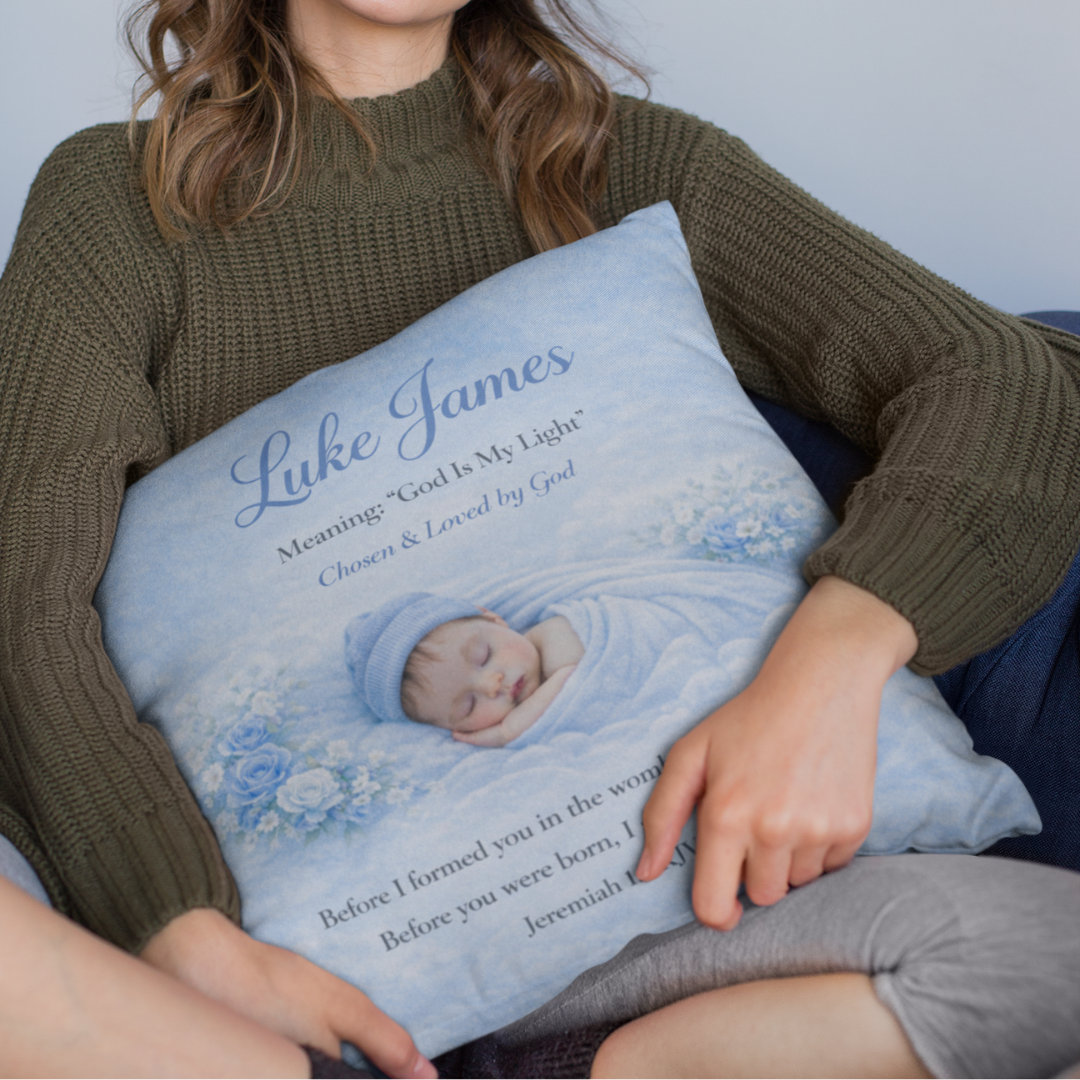 Person holding a personalized baby pillow with a baby's name and a quote.