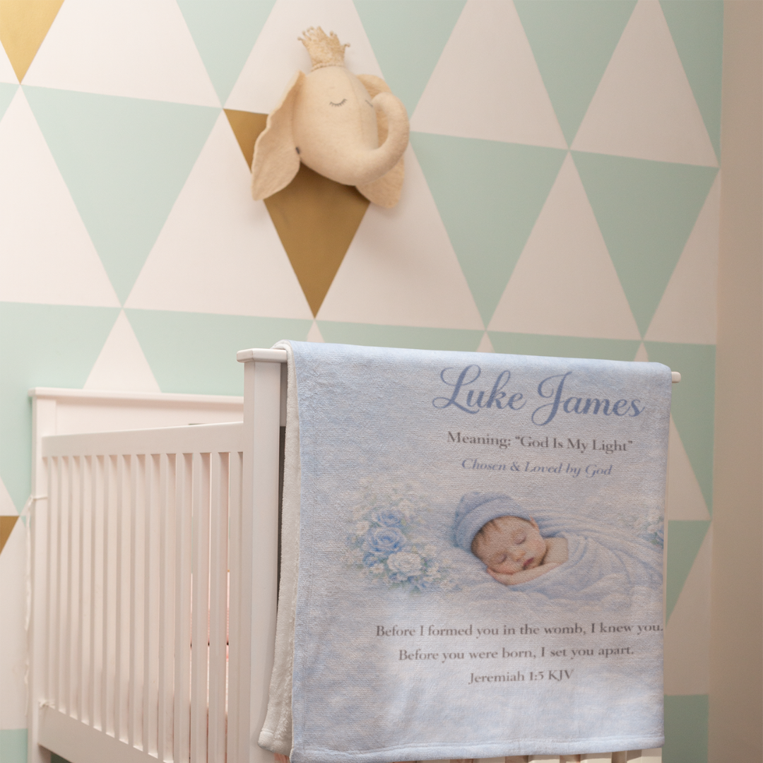 Baby blanket with personalized name and text over a crib in a nursery with geometric wall design.